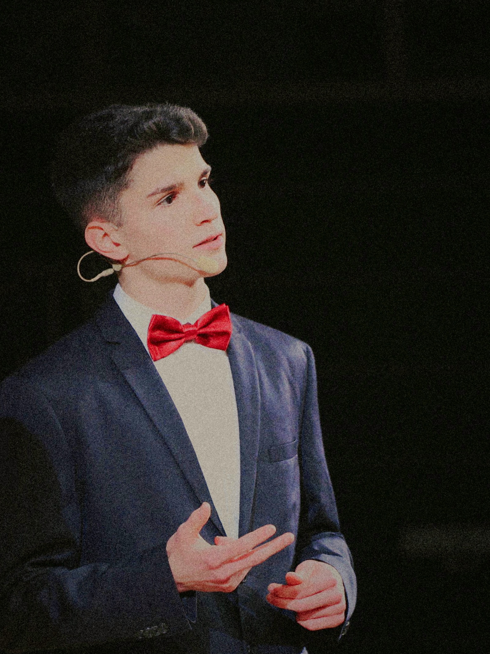 Linus Kern professional portrait in dark formal attire with red bow tie - entrepreneur and brand strategist